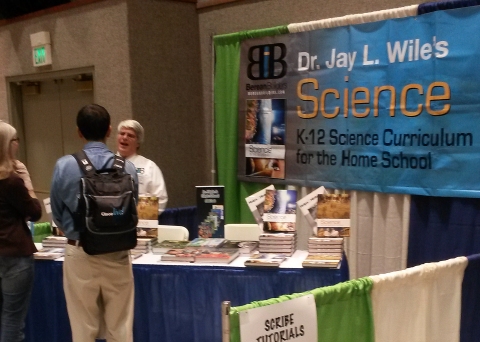 This is me at my publisher's booth talking with two homeschoolers.