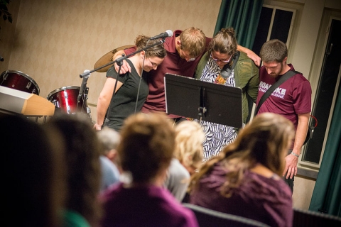 College students pray at an InterVarsity Christian Fellowship meeting.  (click for credit)