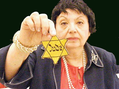 Holocaust survivor Inge  Auerbacher holding the star that she wore in the Terezin concentration camp as a child.